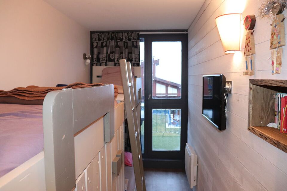 Separate bedroom with bunk beds and a single bed