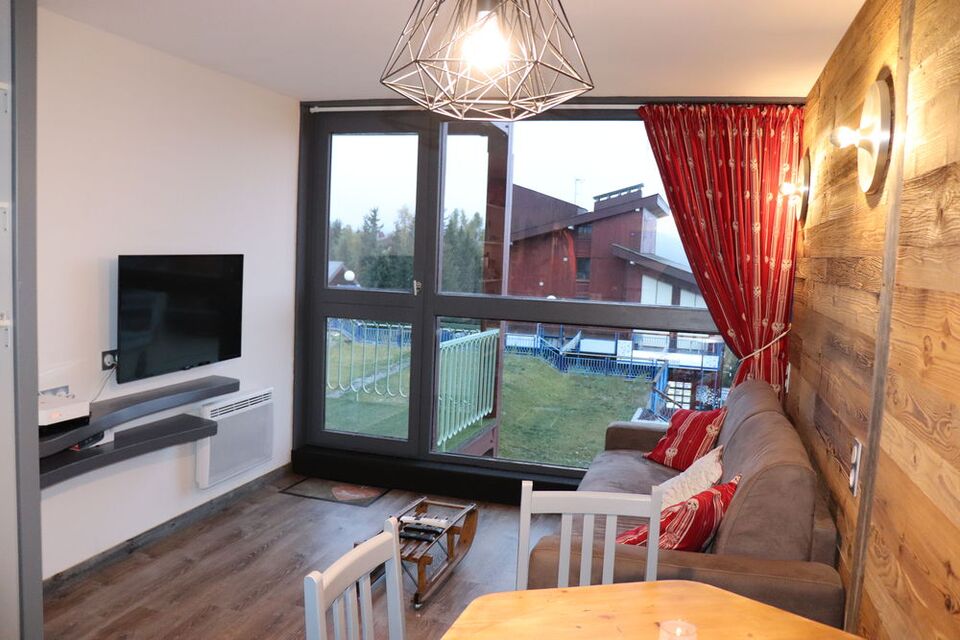 Bright living room with large picture window opening onto the balcony